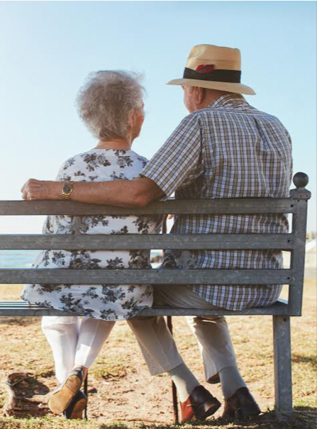 Pareja de mayores sentados en un banco.